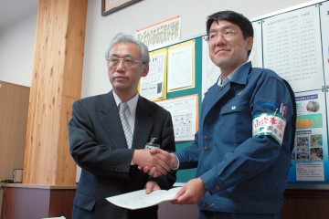 協定締結後、握手する新得町教育委員会委員長と東大雪支署長